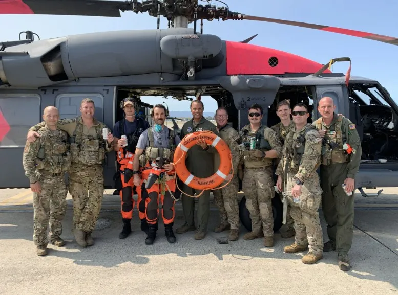Combat search and rescue. Seth Steward with his crew in front of an HH-60 Pave Hawk rescue helicopter on the flight line.