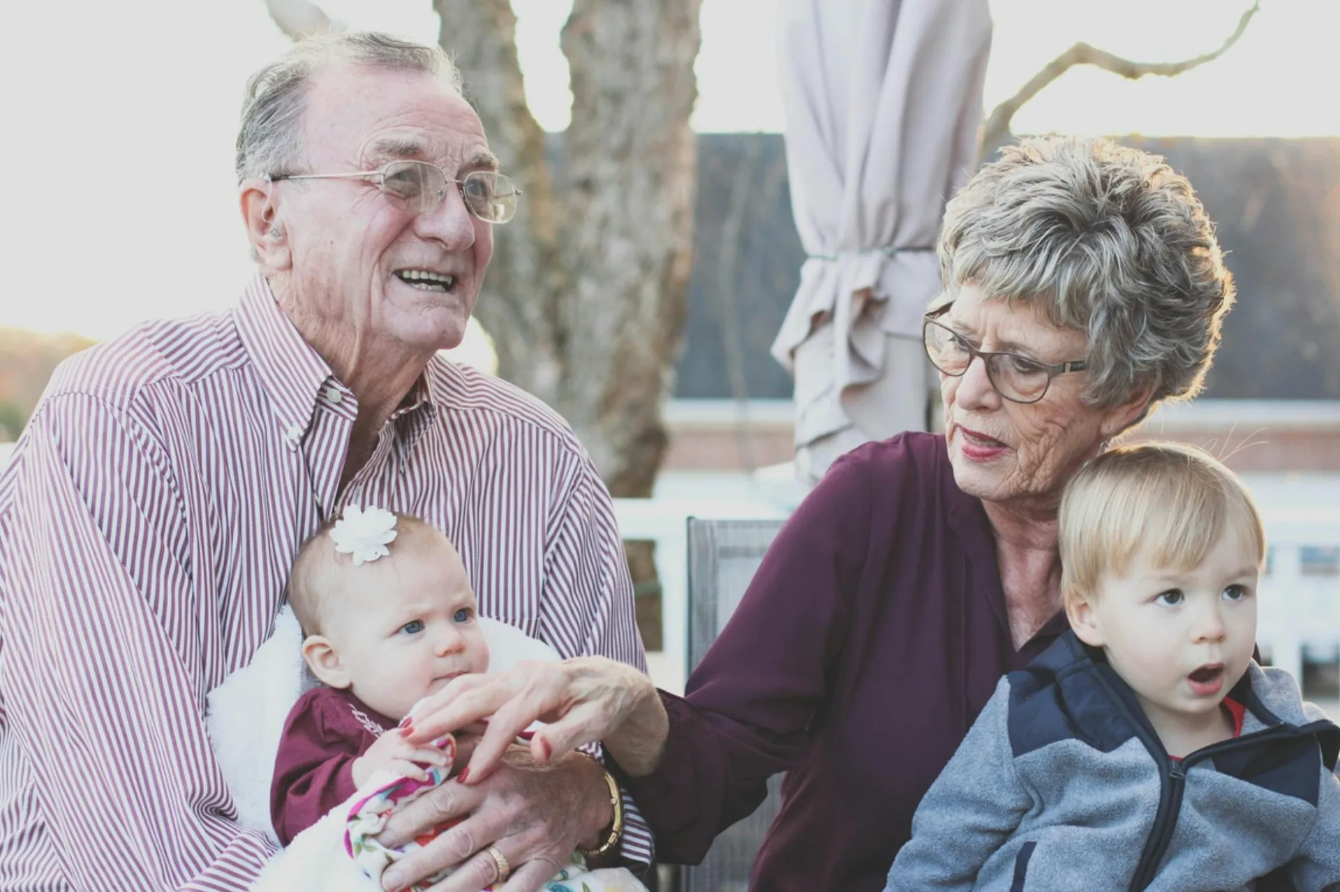 A family holding their children, illustrating generational digital legacies.